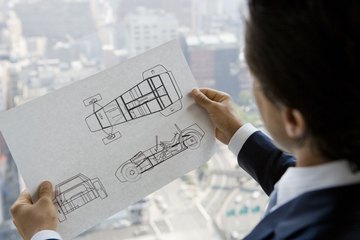 Engineer with design plans Engineer with design plans