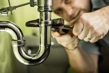 Plumber installing pipes Plumber installing pipes