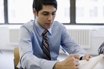 A division controller analyzing a financial document. A division controller analyzing a financial document.