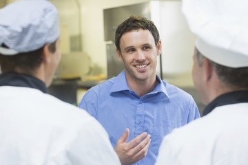 Hotel manager speaking with hotel chefs Hotel manager speaking with hotel chefs