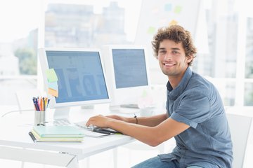 Young man working on computers Young man working on computers
