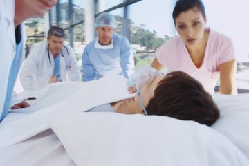 Nurse quickly pushing patient in gurney Nurse quickly pushing patient in gurney
