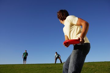 People playing Frisbee on a grassy field. People playing Frisbee on a grassy field.