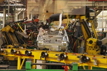 Image of a car on an assembly line being welded. Image of a car on an assembly line being welded.