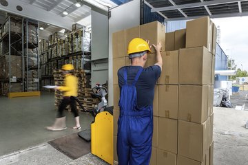 A factory safety worker wearing a hard hat. A factory safety worker wearing a hard hat.