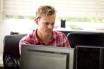Assistant working on two monitors Assistant working on two monitors