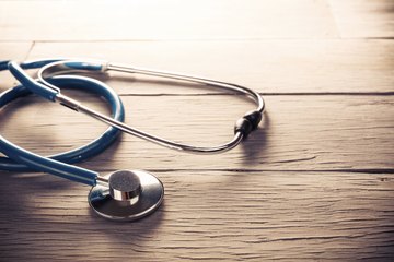 Stethoscope on wood table Stethoscope on wood table
