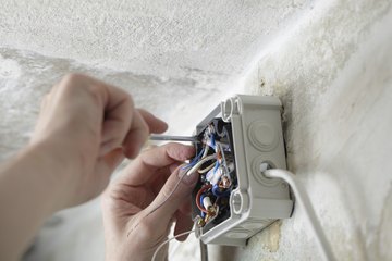 Worker installing electrical box Worker installing electrical box
