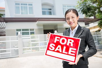 real estate broker with sale sign for house real estate broker with sale sign for house