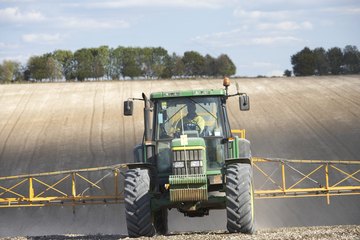 Image of a tractor spraying a field. Image of a tractor spraying a field.