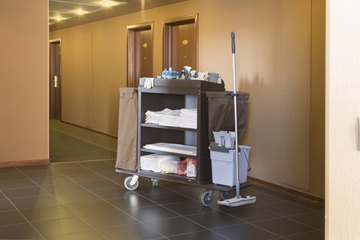 Hotel hallway with cleaning cart. Hotel hallway with cleaning cart.