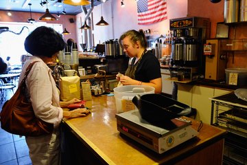 Barista helping customer at counter Barista helping customer at counter