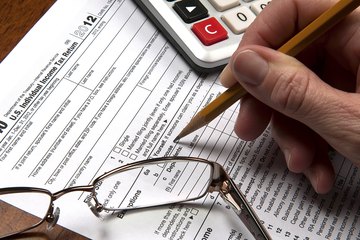 Filling out an income tax form Filling out an income tax form