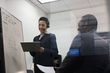 A corporate controller holds a meeting in a conference room. A corporate controller holds a meeting in a conference room.