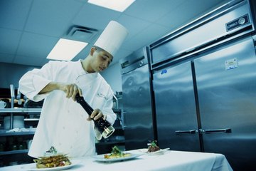 Chef working in front of a large refrigerator Chef working in front of a large refrigerator