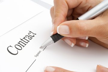 Signing a contract. Signing a contract.