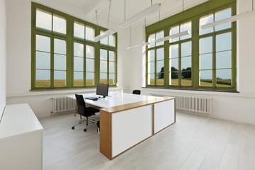 Large double workspace desk in office Large double workspace desk in office