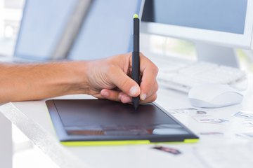 Hand draws on digital design pad Hand draws on digital design pad