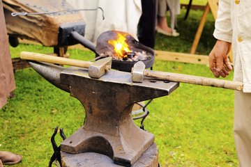 A traditional anvil with hammers ready to be used A traditional anvil with hammers ready to be used
