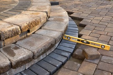Using a level to check patio steps Using a level to check patio steps