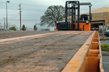 Flatbed truck with trailing forklift. Flatbed truck with trailing forklift.