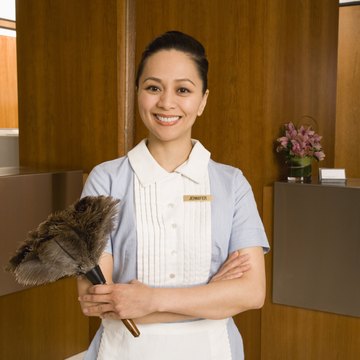 Maid holding feather duster