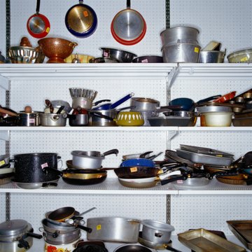 Used pots and pans on store shelf in thrift store, full frame