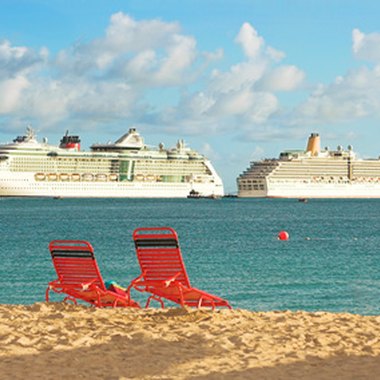 beach chairs and cruise ships image by Elke Dennis from Fotolia.com Two cruise ships prepare to leave port.