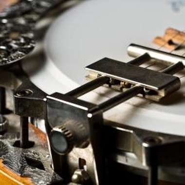 Jupiterimages/Photos.com/Getty Images The bridge of the banjo can be moved to adjust the instrument's intonation.