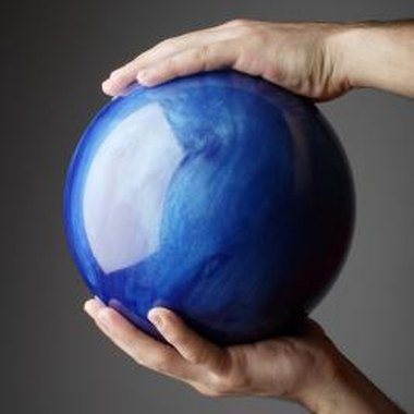 Jupiterimages/Goodshoot/Getty Images Give an old bowling ball new life as a repurposed art or science project.