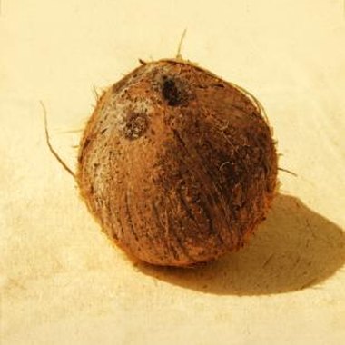 Medioimages/Photodisc/Photodisc/Getty Images Use coconuts to play games at a tropical-themed party for 12-year-olds.