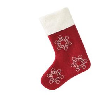 Thomas Northcut/Photodisc/Getty Images Decorate the white cuff of a Christmas stocking with an embroidered name.