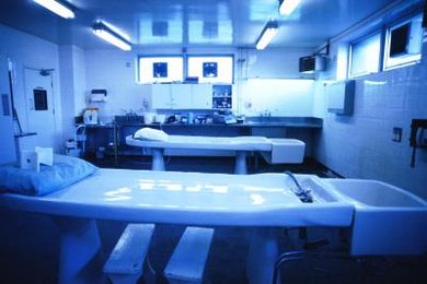 George Doyle/Stockbyte/Getty Images Prospective medical examiners typically have to take take a number of premed courses while in college.
