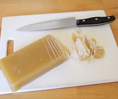 Score the beeswax before cutting it into smaller pieces.