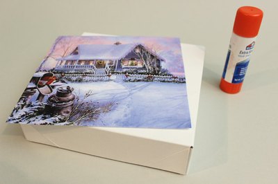 Adhere a snowy image to a box lid.