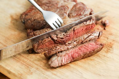 Slicing a rib steak.