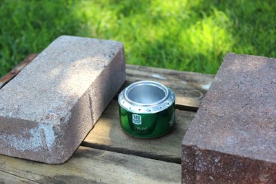 Place stove between two bricks