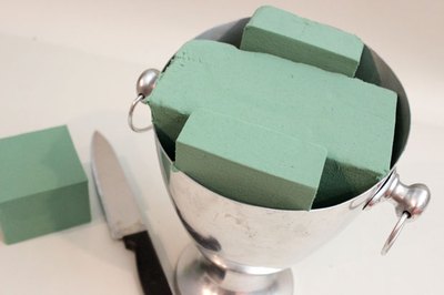 Cut floral foam to fit container