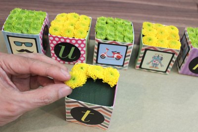 Insert pom poms in the floral foam