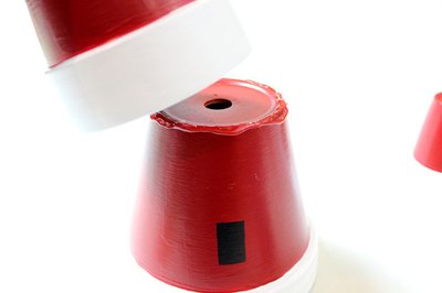 Place the medium pot on top of the large one