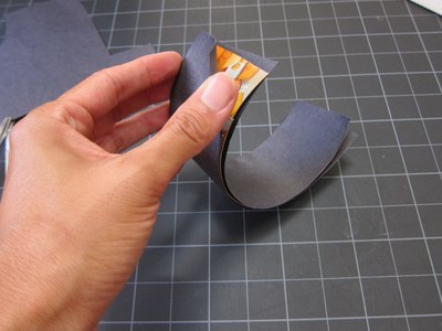 Cover hands in black paper.