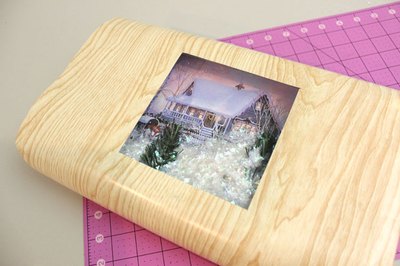 Tape the wrapping paper to the box.