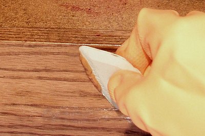 Use a variety of plastic scraper sizes and shapes to fit the contours of the piece you are stripping.