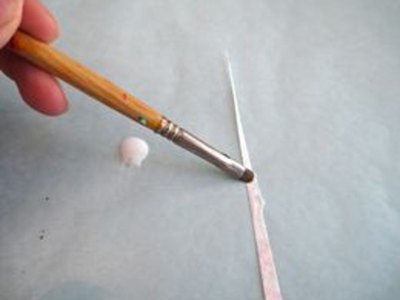 Glue tip of triangle.