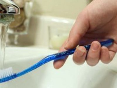 A dampened toothbrush will make the baking soda stick to easier.