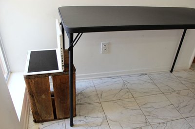 Place a table behind the laptop