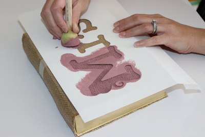A foam brush is the best tool to paint over burlap.