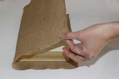Fold burlap carefully, but as quickly as you can. Spray adhesive can get tacky fast.