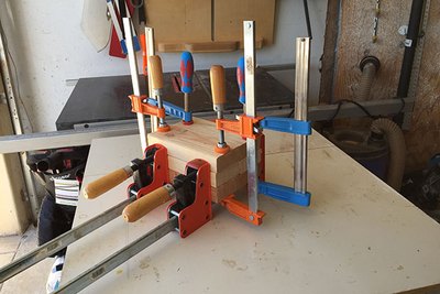 Glue your base and use wood clamps to hold it together.