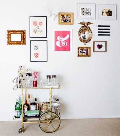 This antique bar cart is balanced by a gallery wall of modern prints.